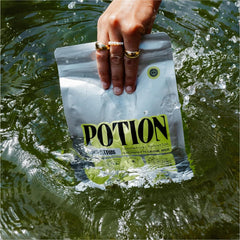 Potion Supernatural Hydration scoop measure demonstrates precise dosing for zero-sugar electrolyte refreshment.
