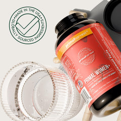 Primal Harvest wellness scene with water and capsules ready to take.