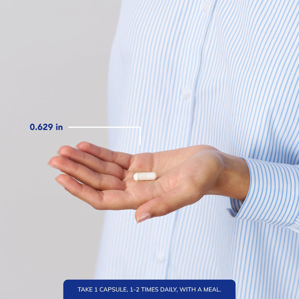 Hand holding PureHeart K2D bottle with easy capsule dosage.