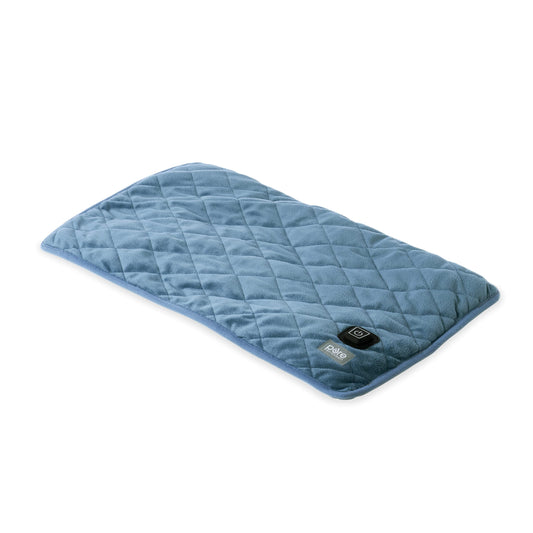 Pure Enrichment WeightedWarmth lap pad on lap provides soothing pressure and warmth.
