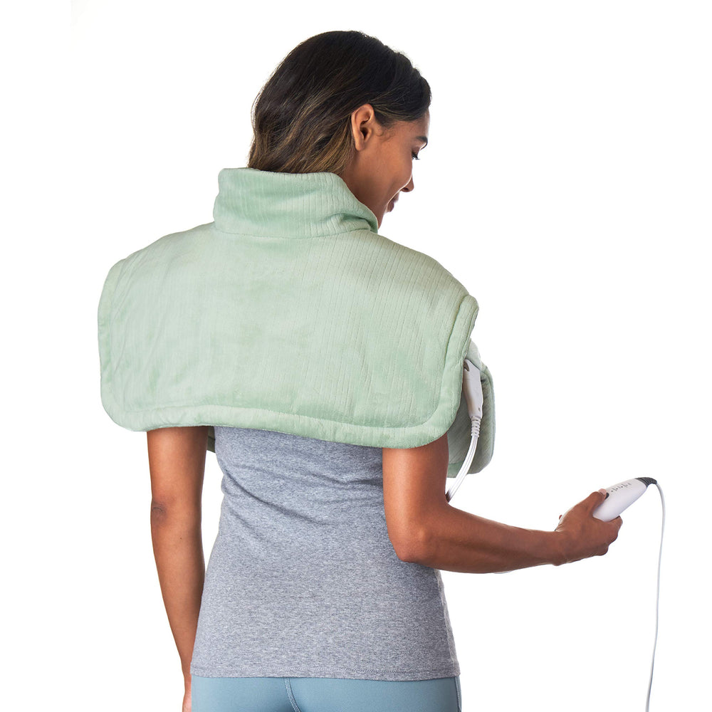Pure Enrichment WeightedWarmth neck and shoulder wrap in use for comforting heat and gentle pressure.