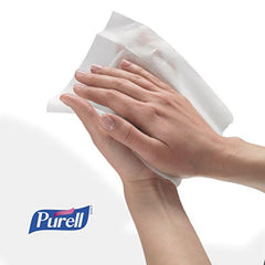 Purell wipes displayed on an office desk for convenient hand hygiene.