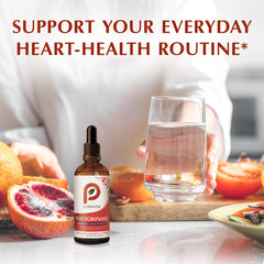 Small glass with PureWise nattokinase drops ready for quick ingestion.