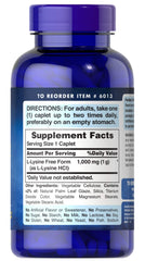 Puritan's Pride L-Lysine caplets close-up, gluten- and soy-free vegetarian formula.