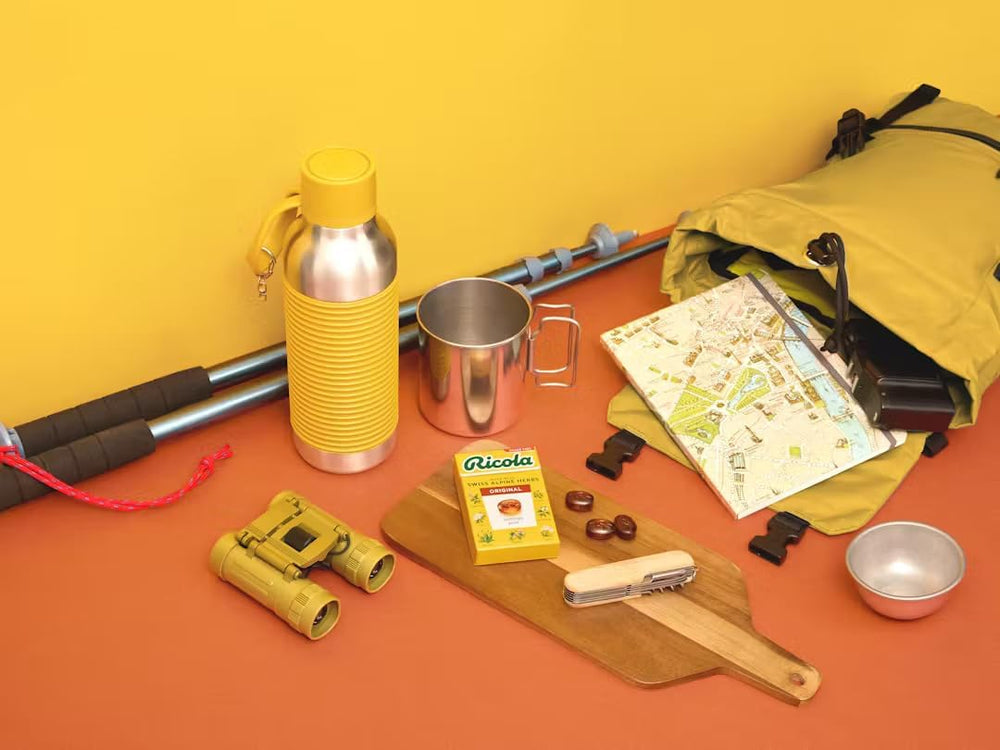 Ricola drops on table with glass of water showing quick use.