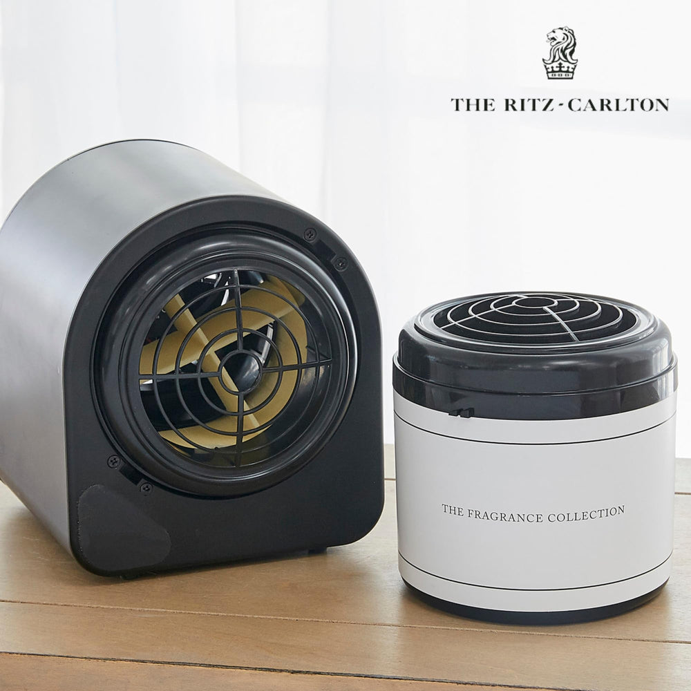 Lifestyle shot shows The Ritz-Carlton scent cartridge enhancing a living room with lush gardenia aroma.