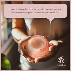 Applying Rosebud Woman Honor balm for intimate hydration.