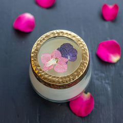 Inside the Rosy Rings candle, pressed florals illuminate softly when lit