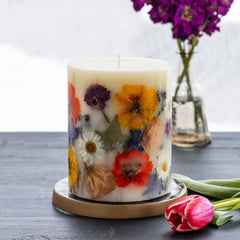 Rosy Rings Essence of Spring candle on a wooden table complements modern decor