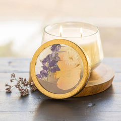 Rosy Rings Vanilla Rain pressed floral candle closeup in glass display for decorative ambiance