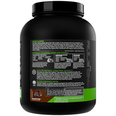 Rule 1 Mass Gainer shake poured in glass shows creamy chocolate fudge.