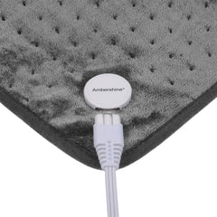 User applying pad to back and shoulders for targeted warmth