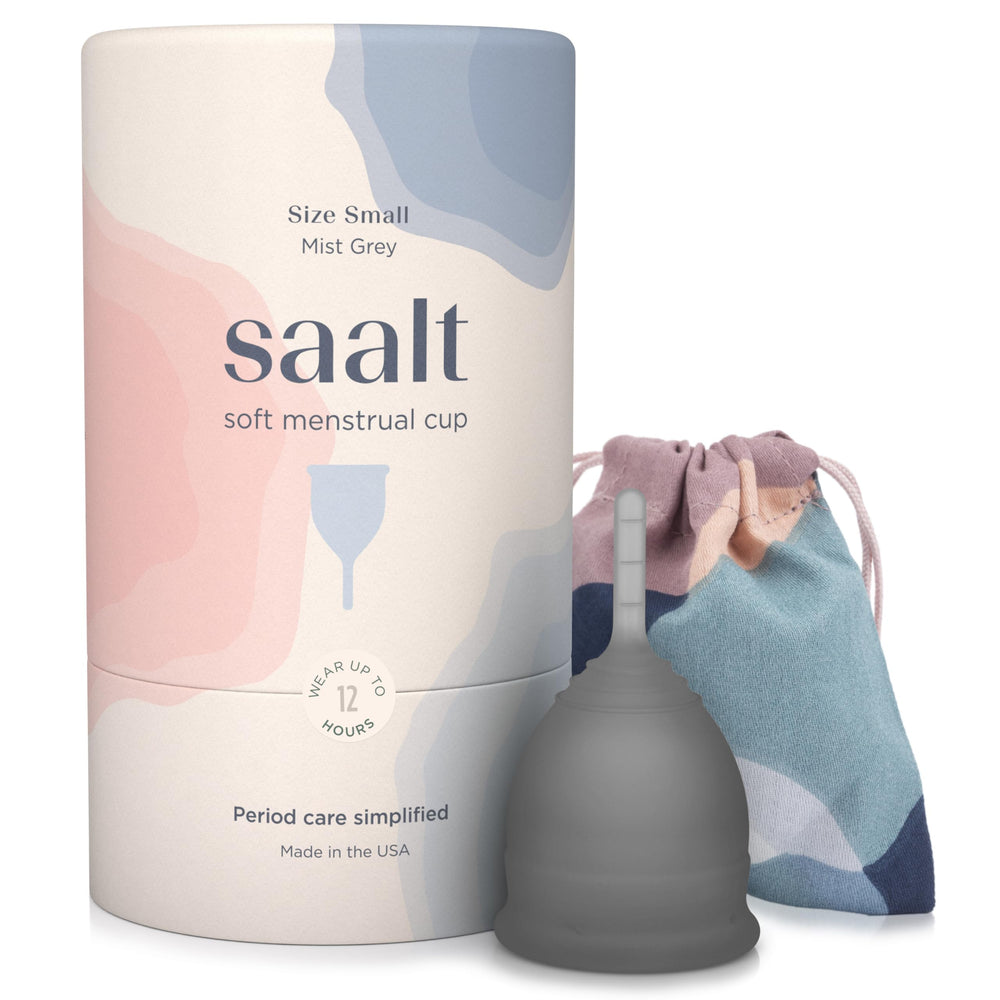 Saalt Soft small grey cup beside calendar highlights travel-friendly reusable option.