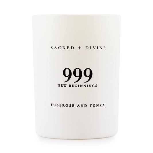 Sacred + Divine 999 candle in a white jar, side view, elevates mindful evenings.