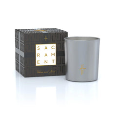 Saint X Ali Landry Sacrament candle in a silver vessel for tranquil evenings.