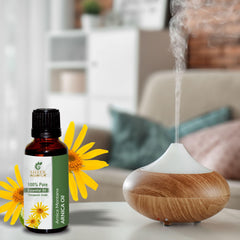 Sheer Essence Arnica Essential Oil amber bottle in diffuser setup for aromatherapy