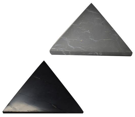 Shungite World polished pyramid 100 mm sits on an office desk for energy balance.