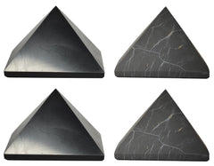 Shungite World polished pyramids 70mm on desk for focused energy protection.
