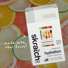 Skratch Labs Hydration Packets beside a glass of water highlighting easy preparation