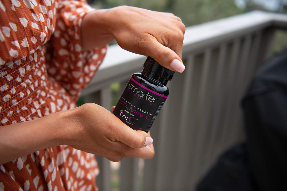 SmarterVitamins Plant-based capsule pouring into a glass suggests easy daily use.