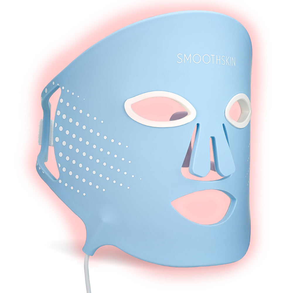 Smootskin DuoLux face mask worn for at-home red light therapy to boost skin vitality.