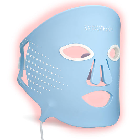 Smootskin DuoLux face mask worn for at-home red light therapy to boost skin vitality.