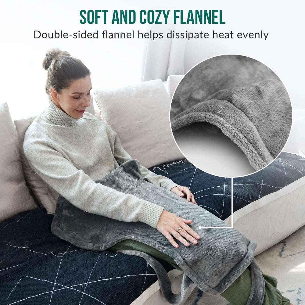 Snailax wearable wrap worn at desk for hands-free heat therapy.