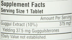 Source Naturals Guggulsterones tablets on kitchen counter for daily routine.