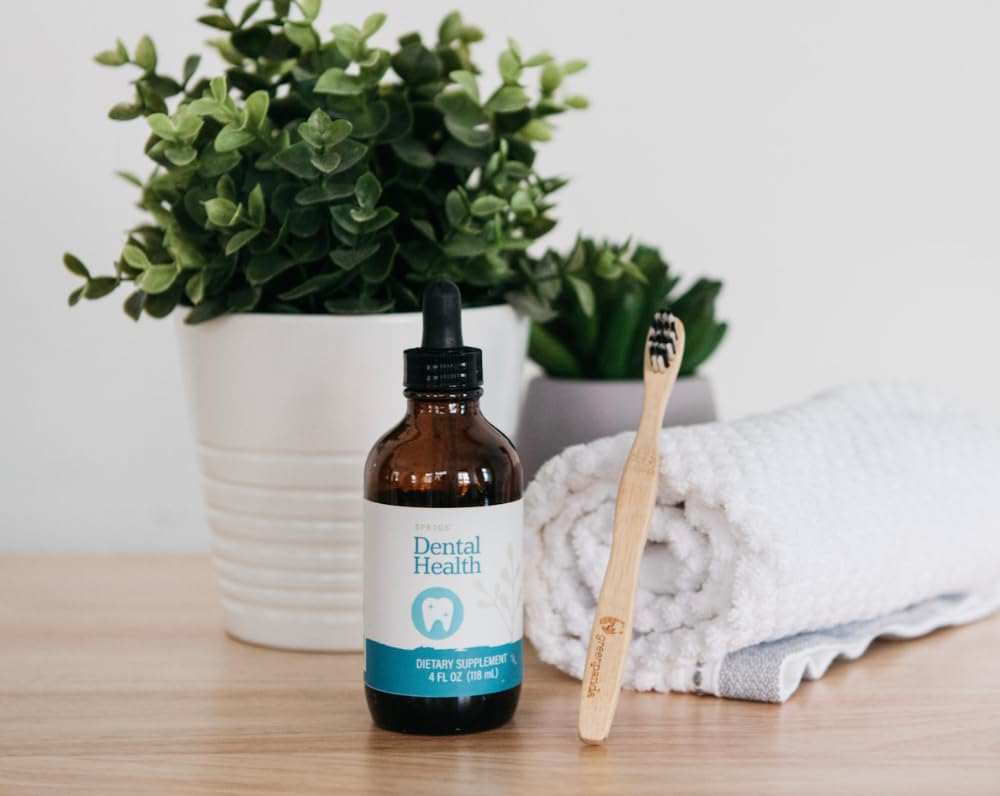 Pouring SPRIGS Dental Health Tincture demonstrates convenient dosage for cleansing.