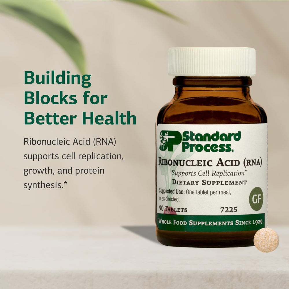 Standard Process RNA bottle sits on a desk, suggesting easy daily intake