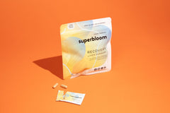 Close-up of Superbloom Recovery Liver Support capsules and packaging.