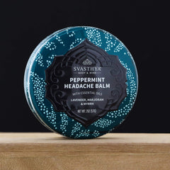 Svasthya Headache Balm applied to temples for a calming scent experience.