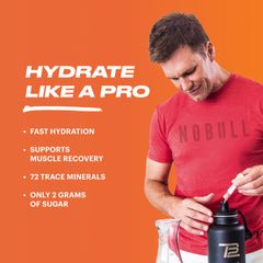 TB12 Peach Mango powder pours into glass for rapid hydration.