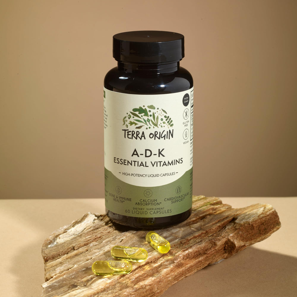 Close-up of Terra Origin ADK liquid capsules for high absorption and easy swallowing.