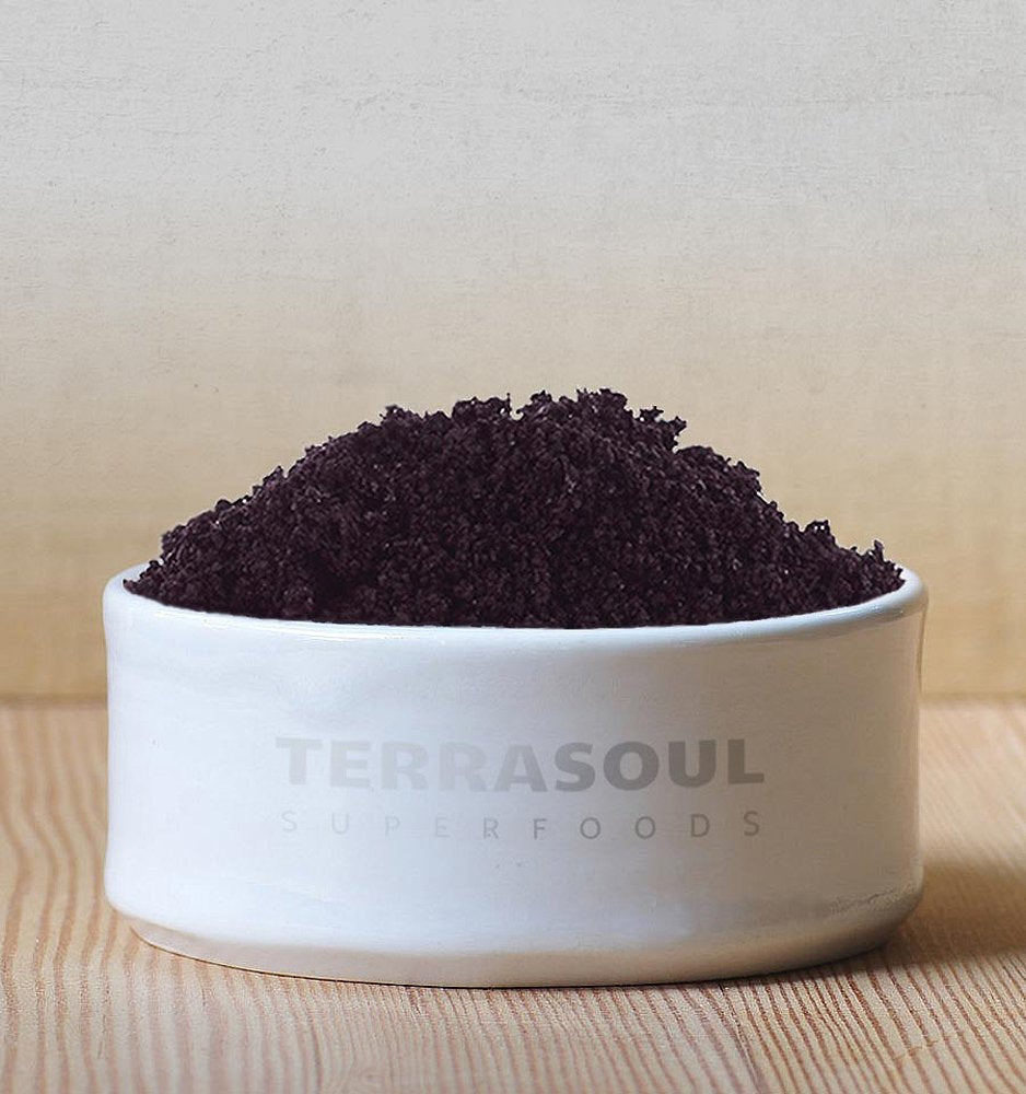 Terrasoul Organic Acai Powder being poured into a smoothie bowl.