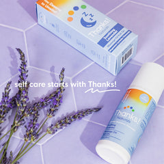 Nightstand display of Thanks! Naturals Massage Oil Roll On for post-shower routines