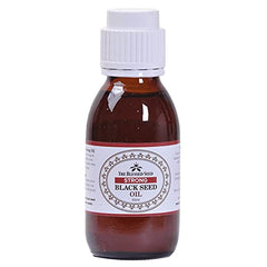 The Blessed Seed oil being poured over food shows versatile daily use.