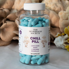The Mushroom Society Chill Pill bottle on a nightstand suggests unwinding after a long day.