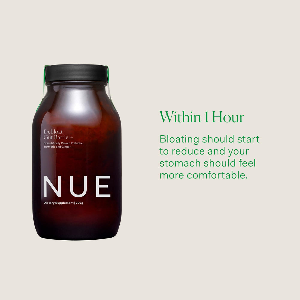 The Nue Co Debloat powder scoop with coconut milk base in a clear jar for easy daily mixing.