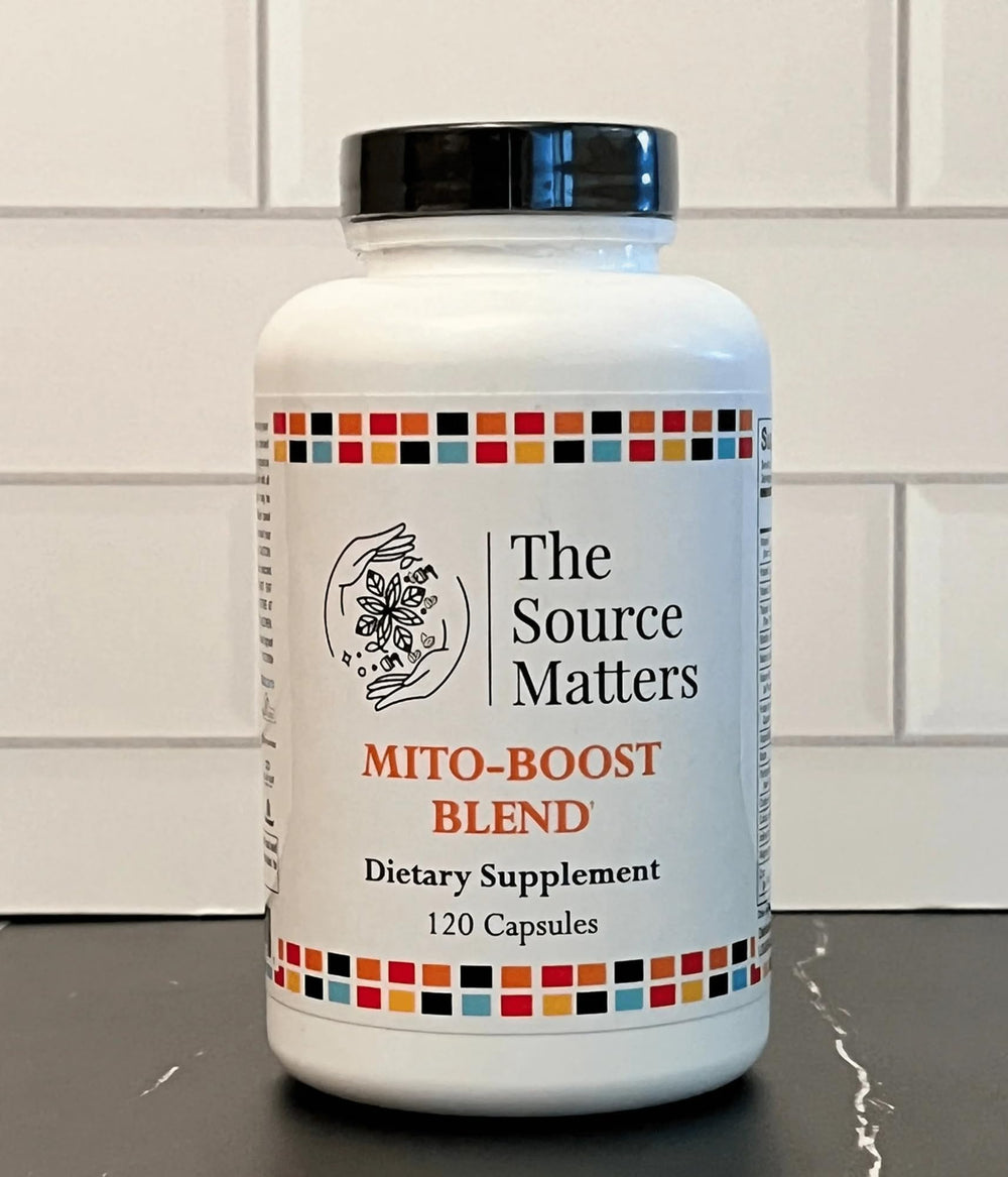 The Source Matters Mito-Boost scene with capsules and a glass of water