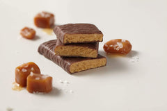 thinkThin Salted Caramel bar on desk ready for a quick protein snack