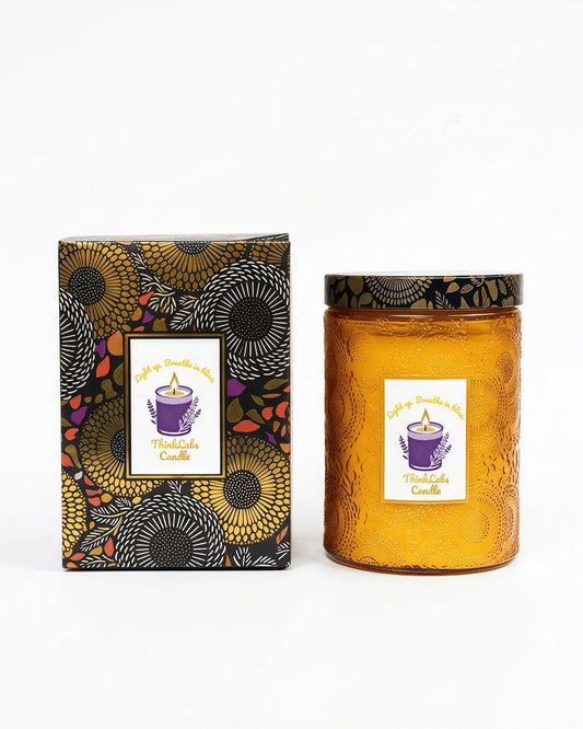 ThinkLabs organic daisy cedar candle in embossed jar for long-lasting ambiance.