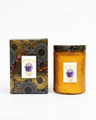 ThinkLabs organic daisy cedar candle in embossed jar for long-lasting ambiance.