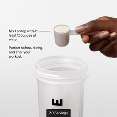 Serving scoop beside the tub highlights calorie-free sweeteners and low carbs.