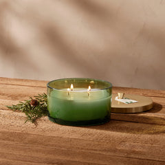 Thymes Frasier Fir candle with brushed gold lid adds festive decor.