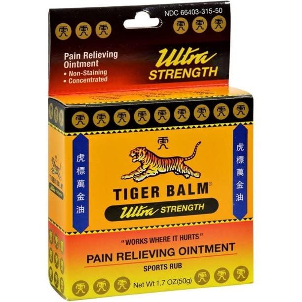 Applying Tiger Balm Sport Rub to shoulder for targeted massage