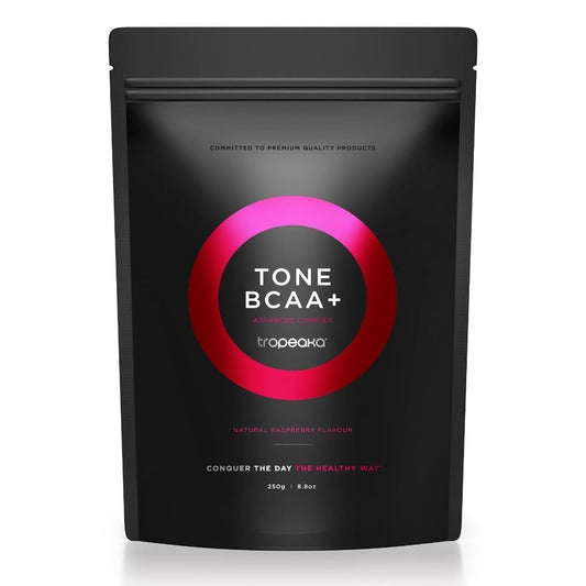 Tropeaka Tone BCAA+ tub on gym counter for lean muscle support.