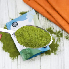 True Moringa regenerative organic moringa powder close-up highlights vibrant green leaves.