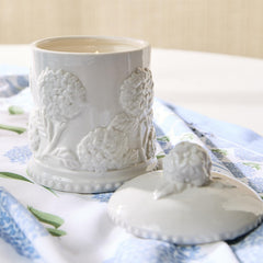 Two's Company hydrangea relief candle with intricate relief design enhances decor detail.