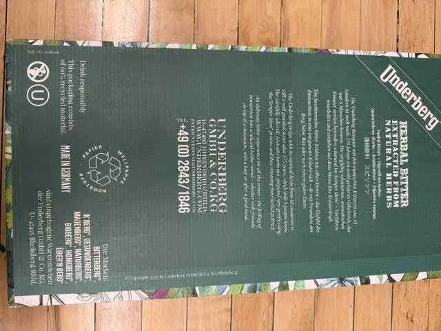 Underberg bottle inside straw-paper wrap signaling portable digestive support